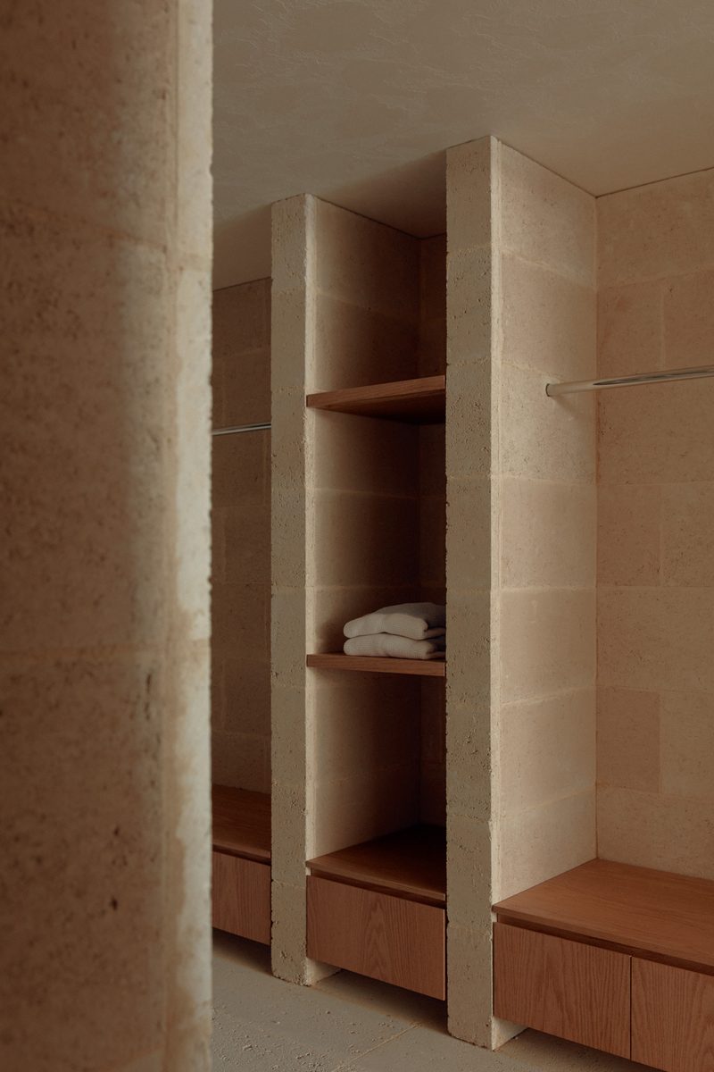 Travertine shelving niche with timber bench