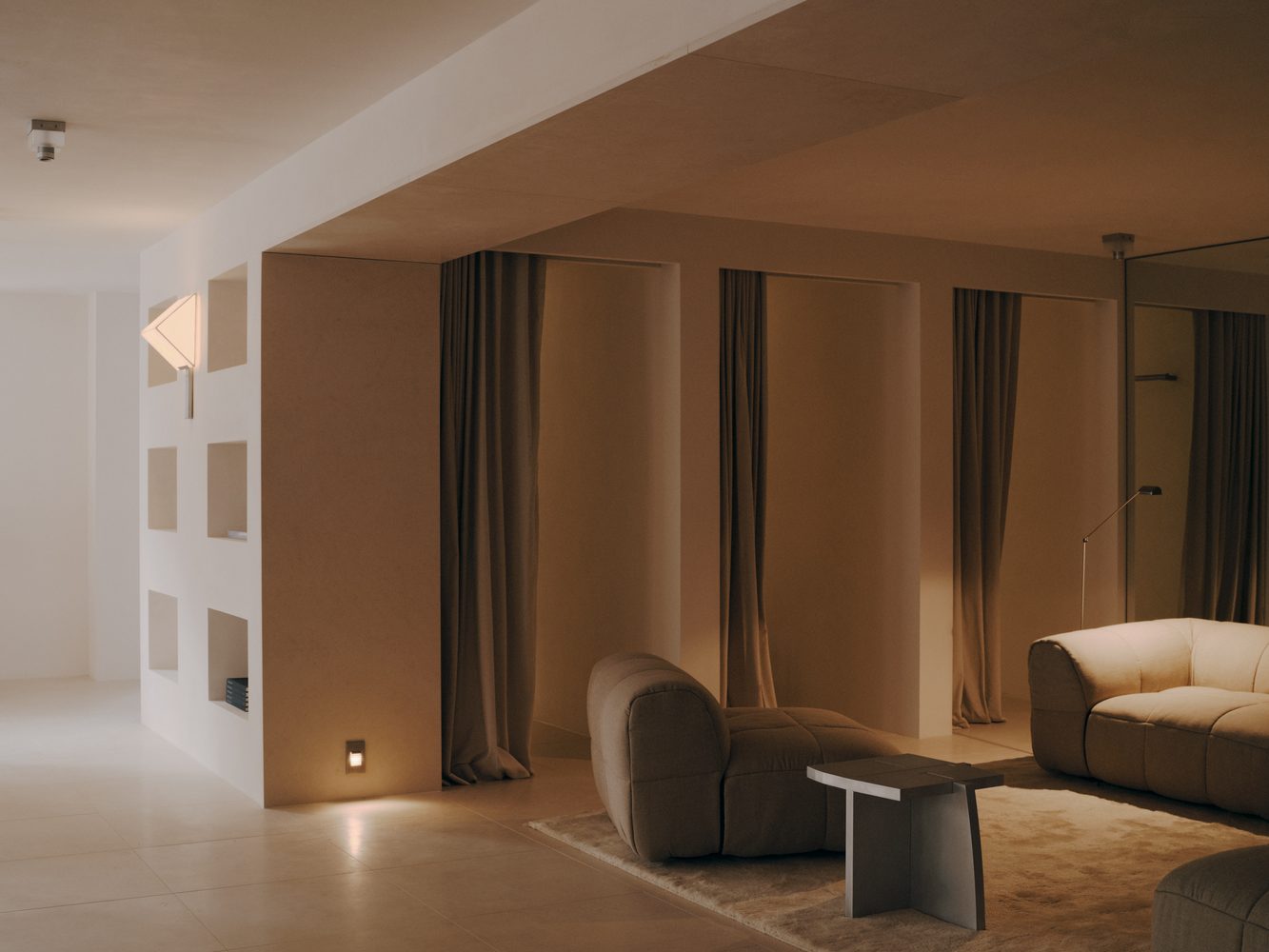 Sitting room with a low lounge chair and dark curtains