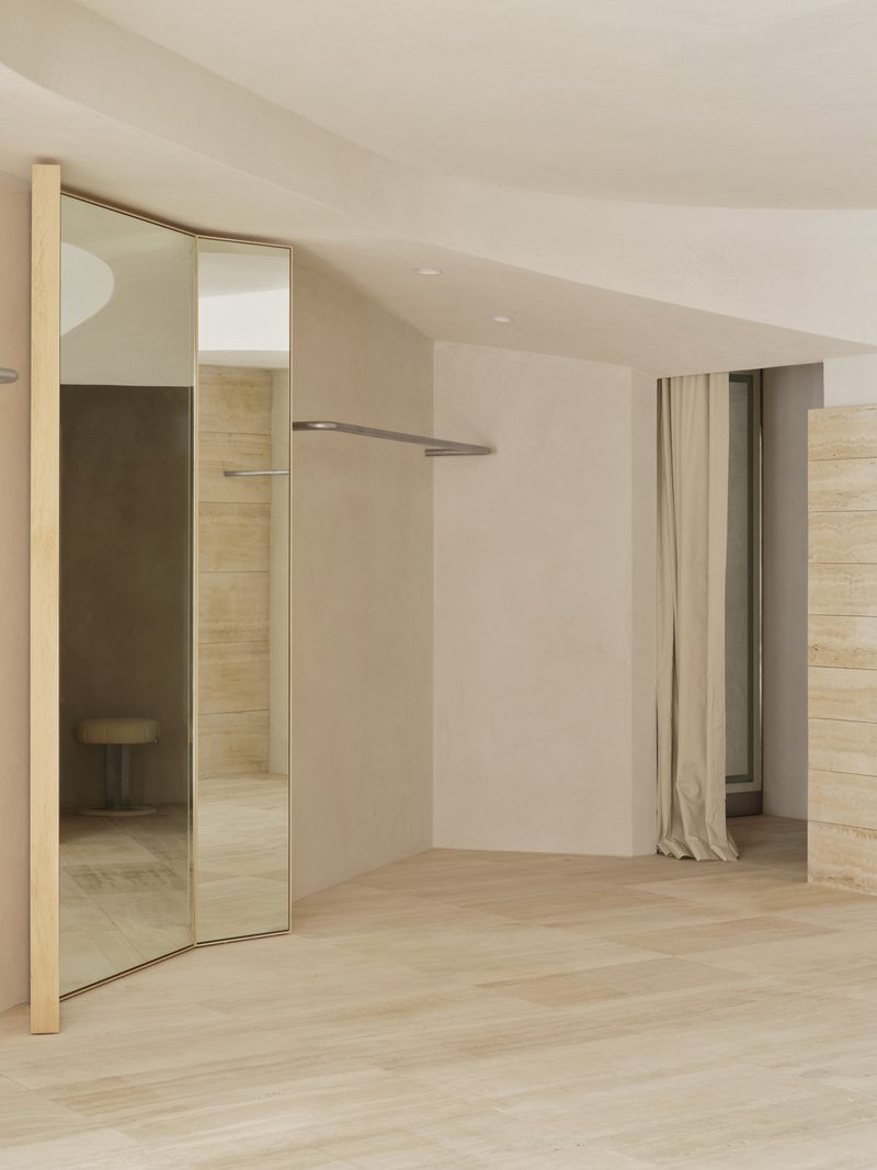 Mirrored door opening onto a curtained room
