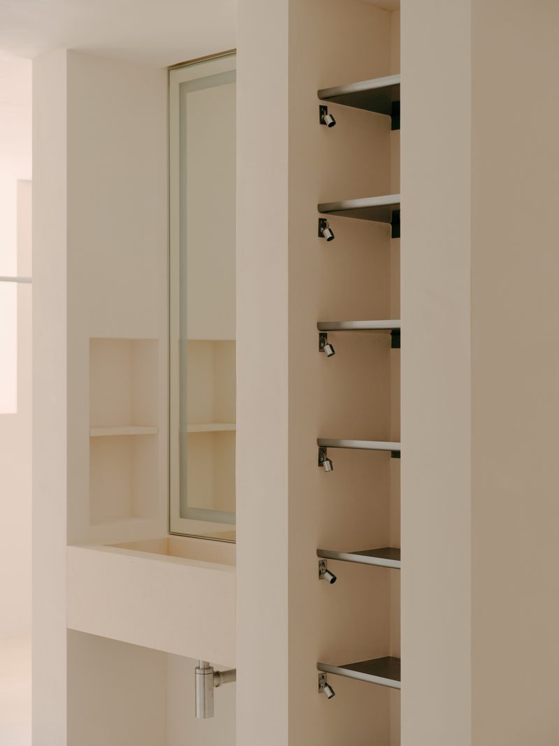 White cabinet with steel shelf pegs
