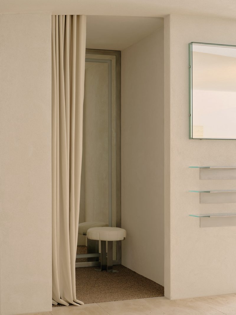 Linen curtain partially drawn across a doorway