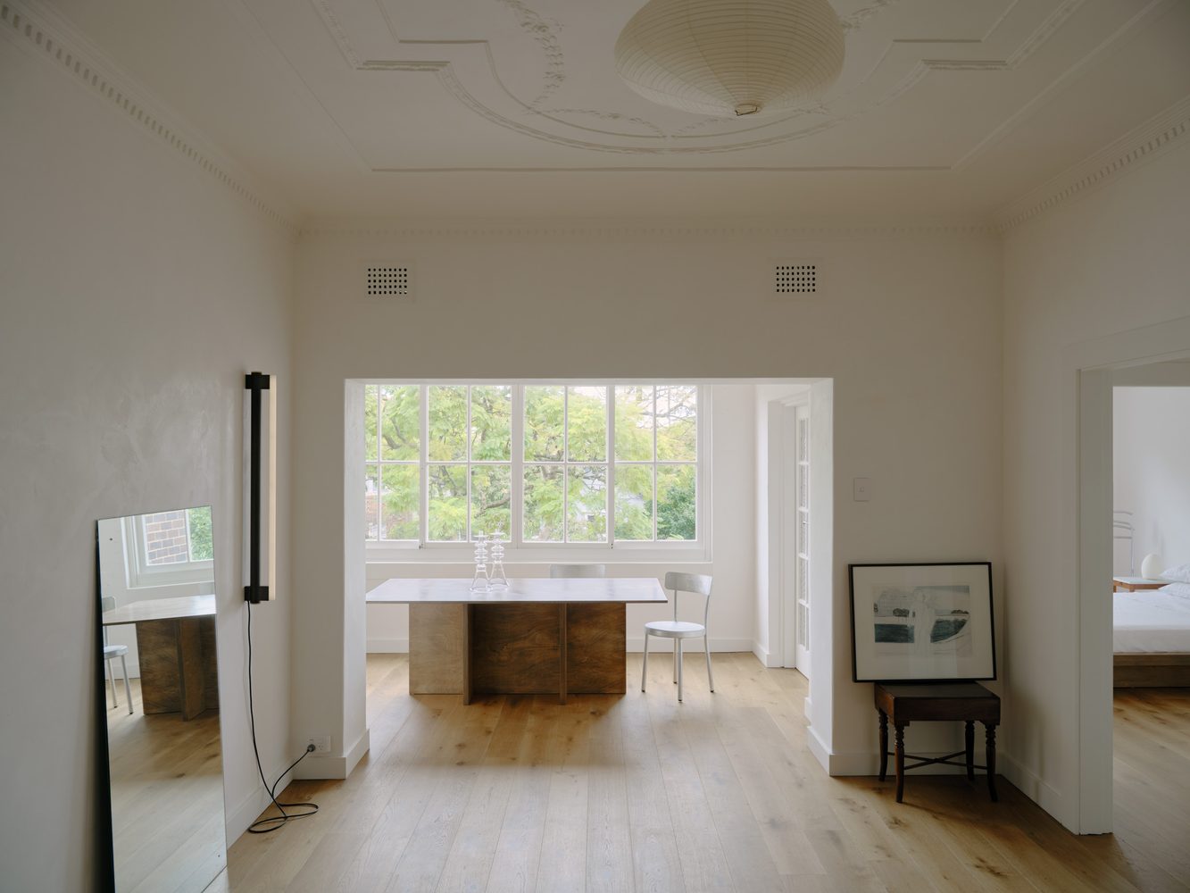 Dining room with a stone table beneath an ornate ceiling rose